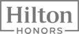 This image features the logo for Hilton Honors, a loyalty program by Hilton Hotels.